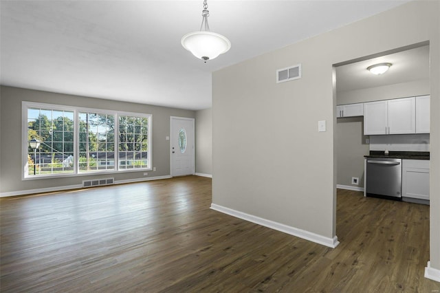 unfurnished living room with dark hardwood / wood-style flooring