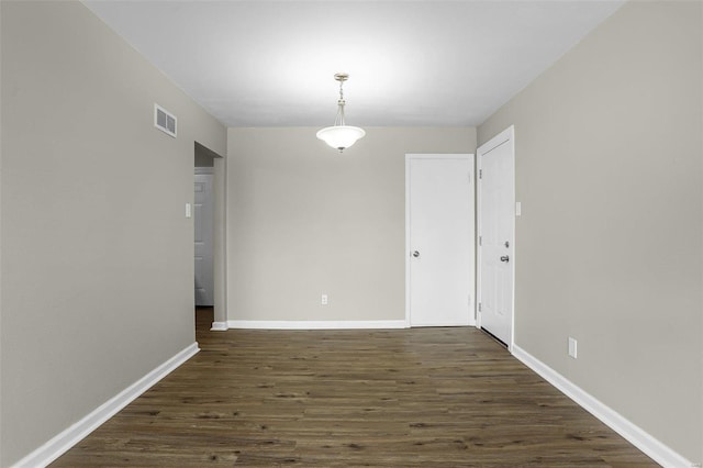 unfurnished dining area featuring dark hardwood / wood-style flooring