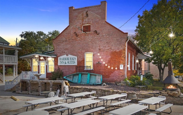 back house at dusk with a patio