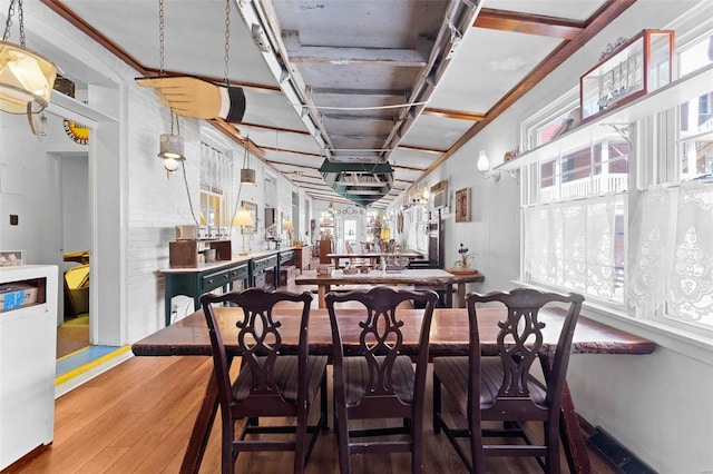 dining room featuring wood-type flooring and indoor bar