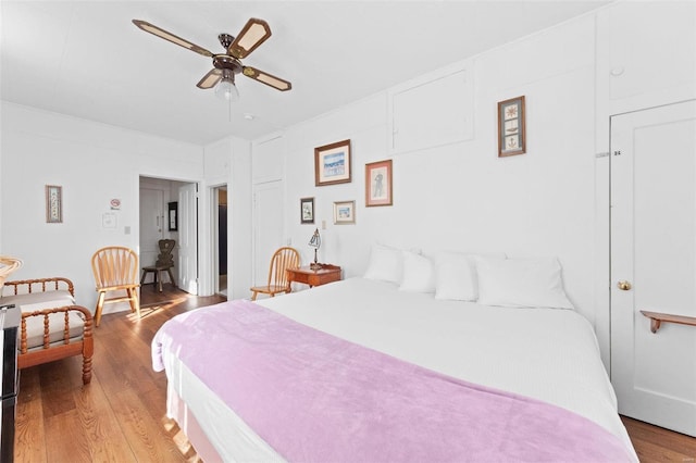 bedroom with hardwood / wood-style flooring and ceiling fan