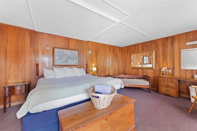 carpeted bedroom featuring wooden walls