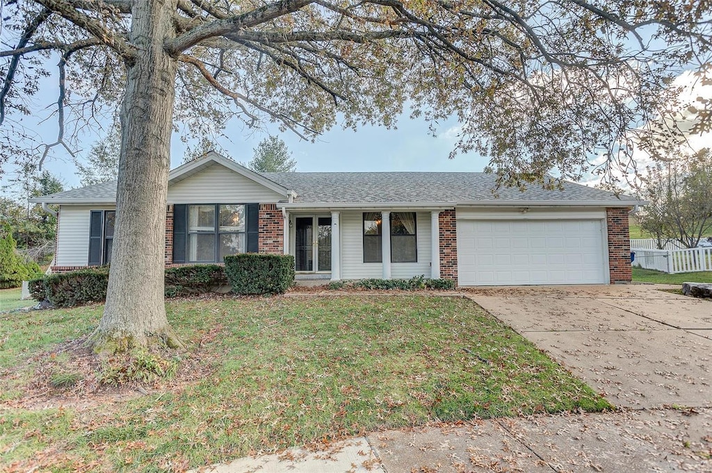 ranch-style home with a garage and a front yard