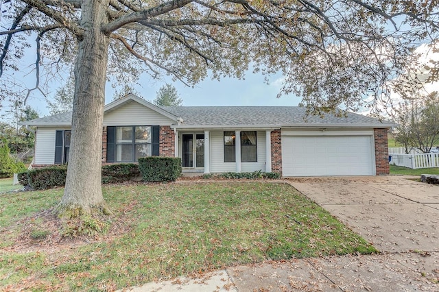 ranch-style home with a garage and a front yard