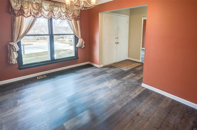 unfurnished dining area with dark wood-type flooring