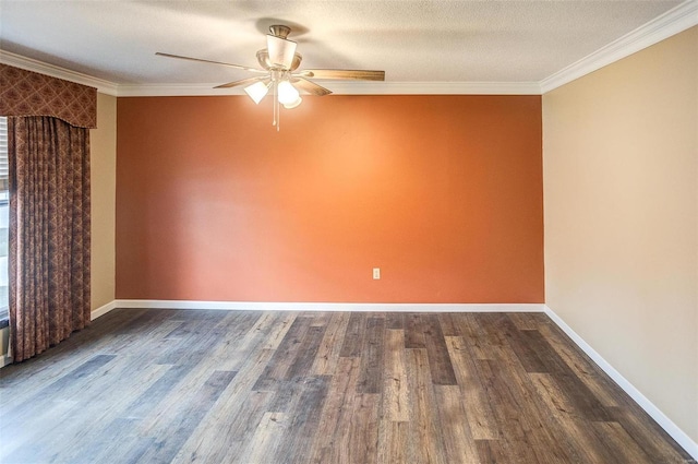 spare room with dark hardwood / wood-style floors, a textured ceiling, and ornamental molding