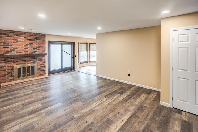 unfurnished living room with dark hardwood / wood-style flooring and a fireplace