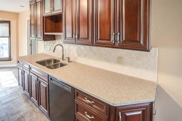 kitchen featuring decorative backsplash, sink, light tile patterned floors, and black dishwasher