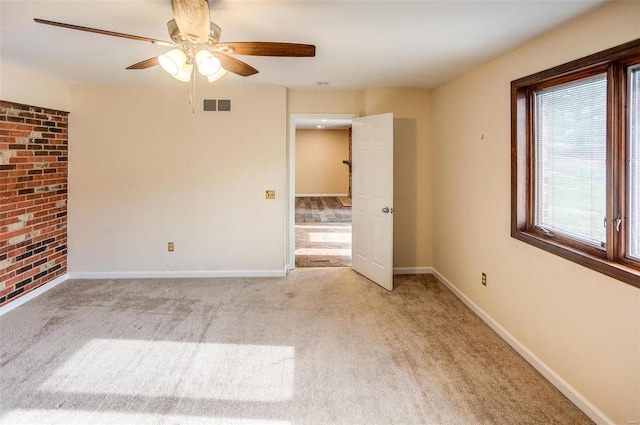 carpeted empty room featuring ceiling fan