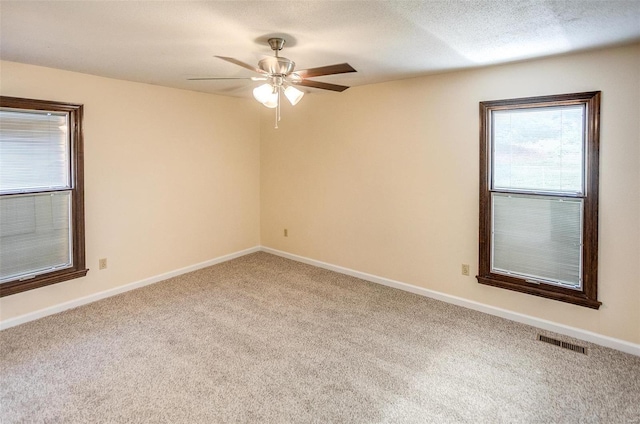 spare room featuring carpet flooring and ceiling fan