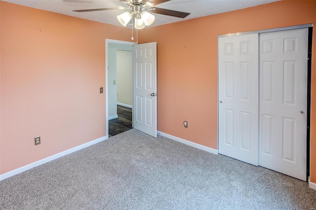 unfurnished bedroom with ceiling fan, a closet, and carpet floors