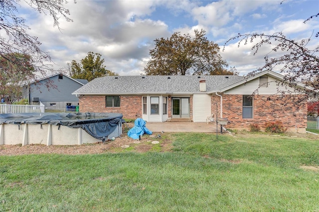 back of house with a patio area, a yard, and a covered pool