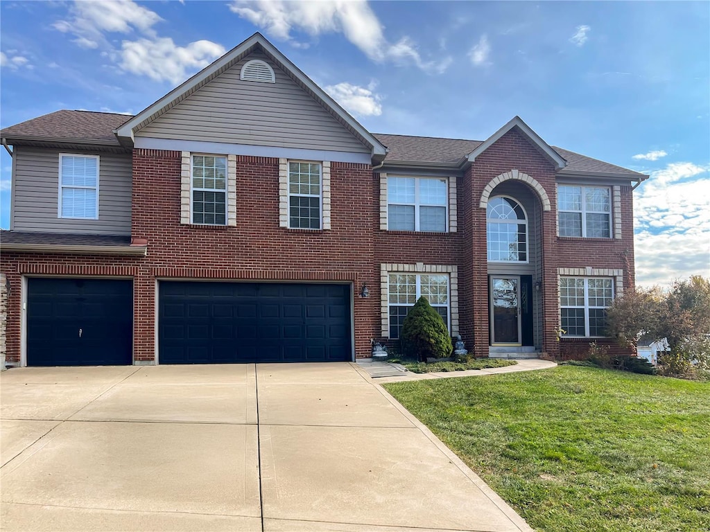 view of front of house with a front lawn and a garage