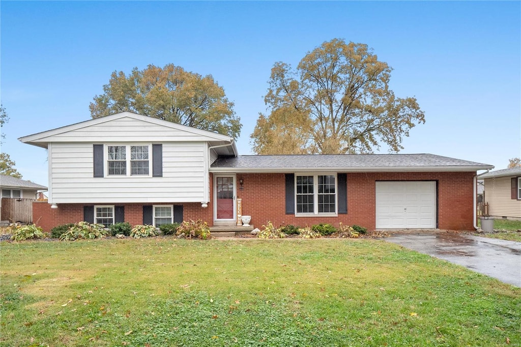 split level home featuring a garage and a front lawn