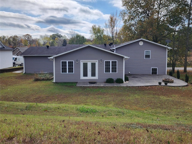 back of property with a lawn, a patio area, and french doors