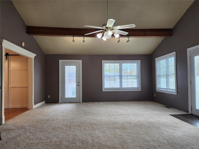 unfurnished living room featuring vaulted ceiling with beams, ceiling fan, carpet floors, and a textured ceiling