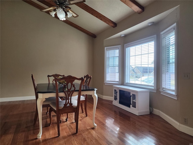 dining area featuring hardwood / wood-style flooring, vaulted ceiling with beams, and ceiling fan