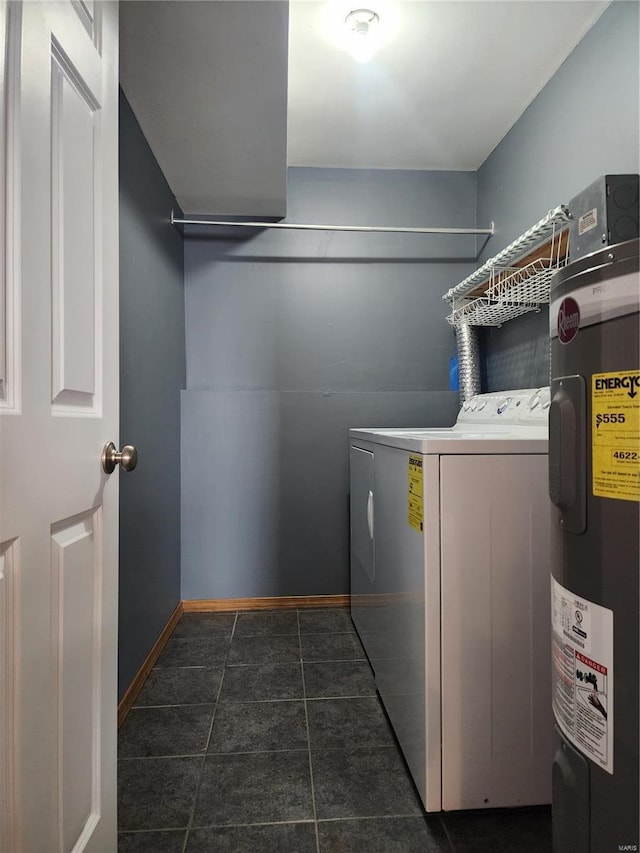 clothes washing area featuring separate washer and dryer, electric water heater, and dark tile patterned floors