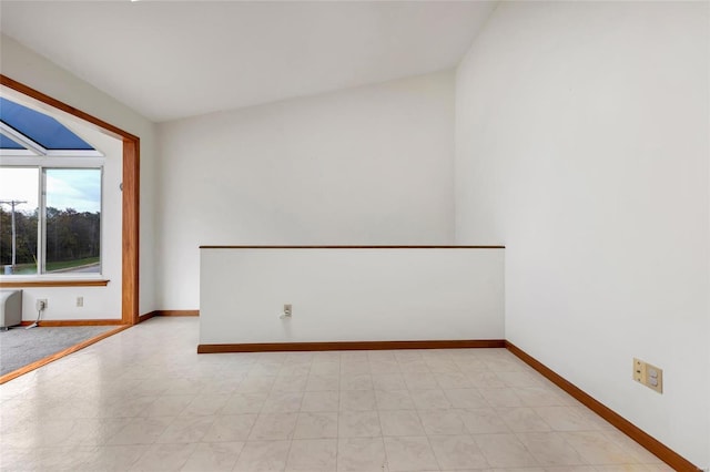 spare room featuring vaulted ceiling