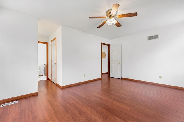 spare room featuring ceiling fan and dark hardwood / wood-style flooring