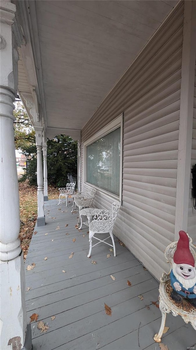 wooden terrace featuring covered porch