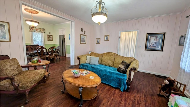 living room featuring wood-type flooring and crown molding