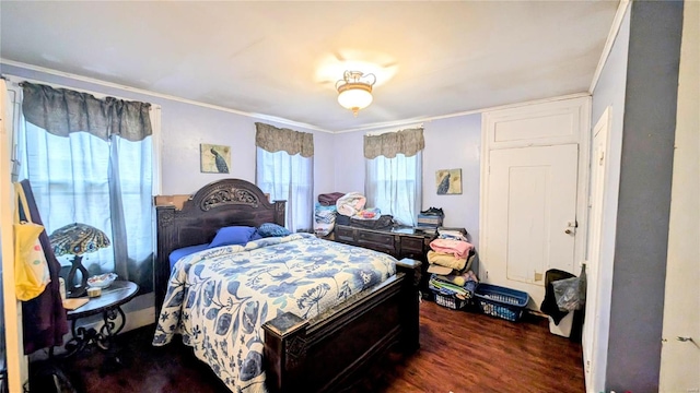 bedroom featuring dark hardwood / wood-style flooring and crown molding