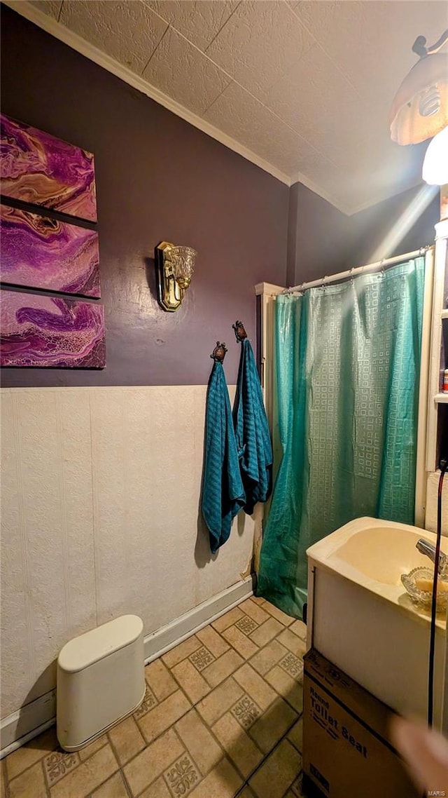 bathroom with vanity and ornamental molding