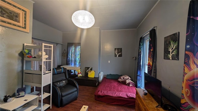 bedroom featuring dark hardwood / wood-style floors and crown molding