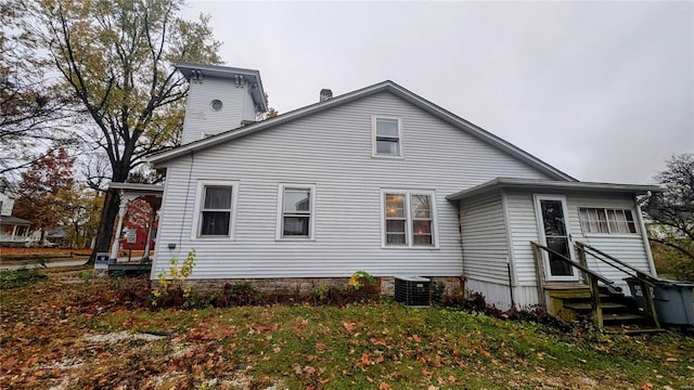 rear view of property with cooling unit