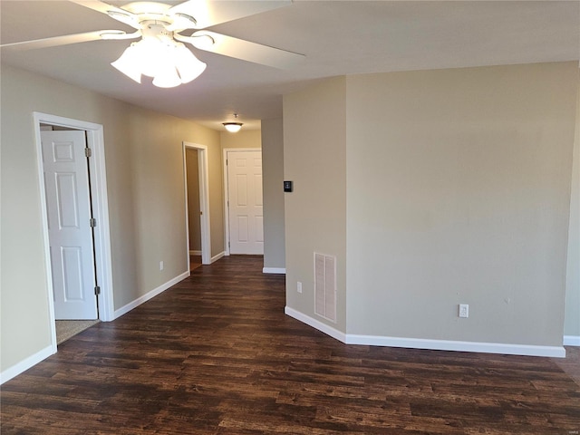 empty room with dark hardwood / wood-style flooring and ceiling fan