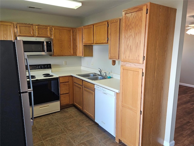 kitchen with white appliances, dark hardwood / wood-style floors, and sink