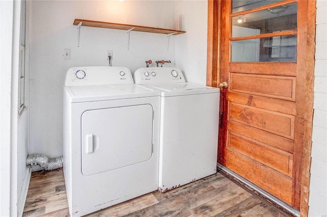 washroom with light hardwood / wood-style flooring and independent washer and dryer