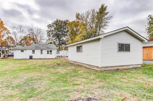 back of property featuring a lawn