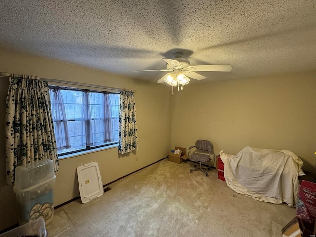 interior space featuring a textured ceiling, light carpet, and ceiling fan