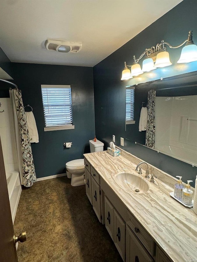 full bathroom with vanity, toilet, and shower / tub combo