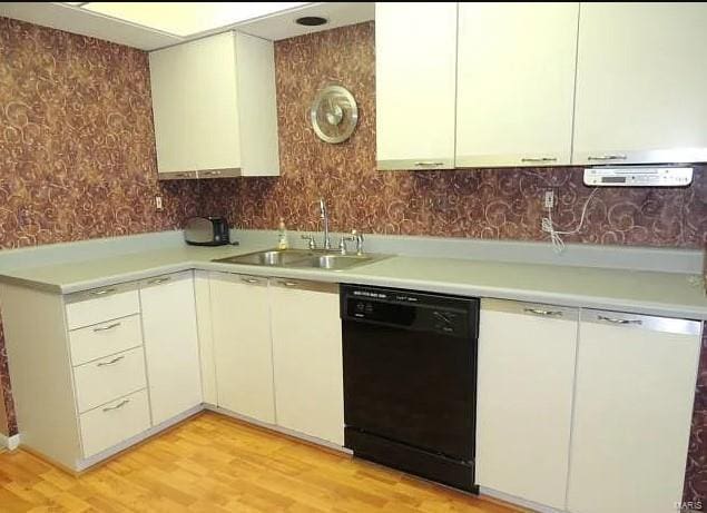 kitchen featuring dishwasher, light hardwood / wood-style flooring, and sink