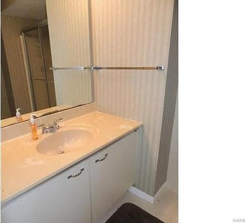 bathroom with vanity and a shower with shower door