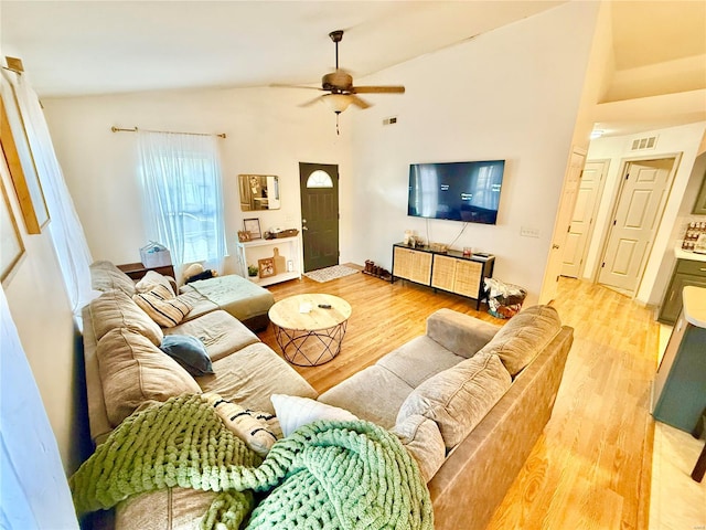 living room with vaulted ceiling, ceiling fan, and wood-type flooring