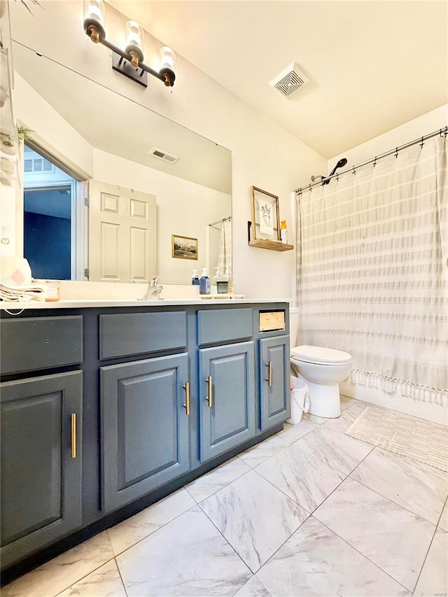 full bathroom with shower / bath combo, vanity, and toilet