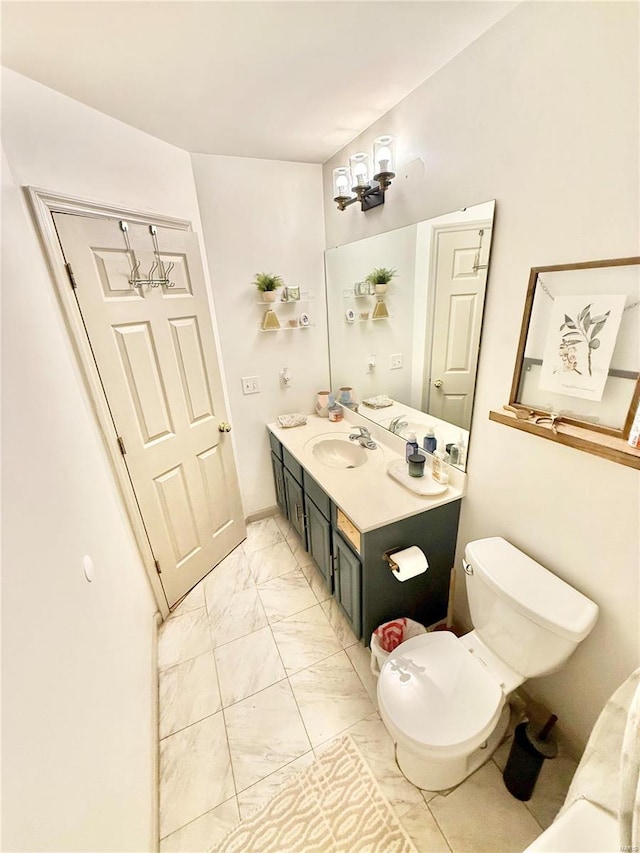 bathroom featuring toilet and vanity