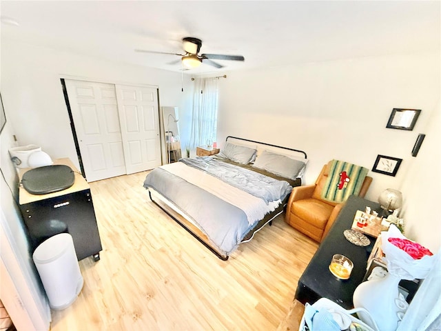 bedroom featuring a closet, wood-type flooring, and ceiling fan