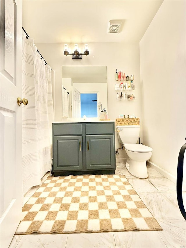 bathroom with toilet and vanity