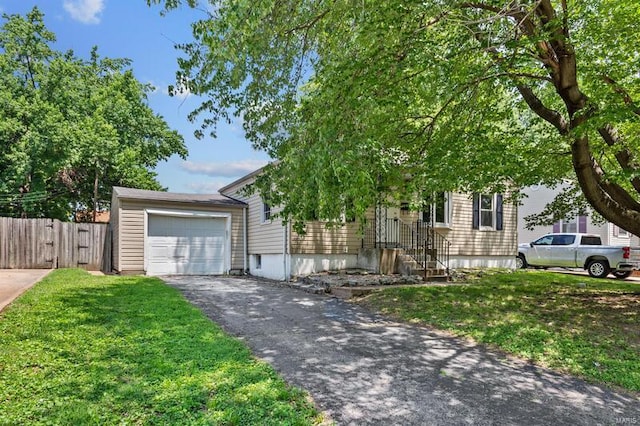 view of front of house featuring a garage and a front lawn