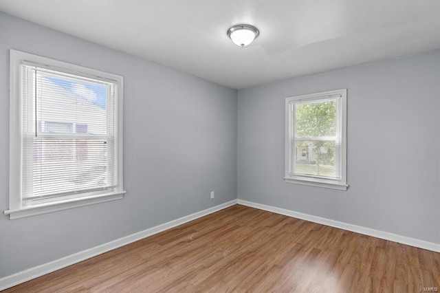 unfurnished room with light wood-type flooring and plenty of natural light