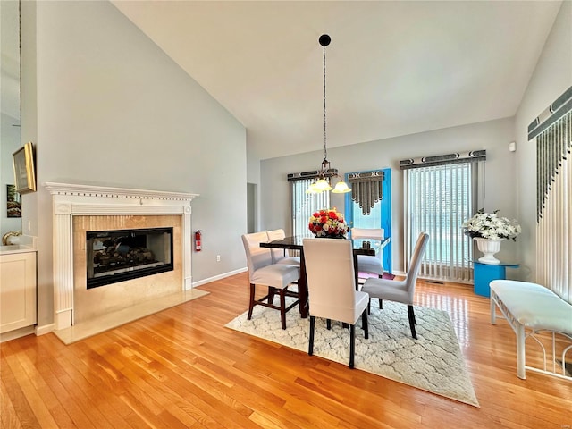 dining room featuring a wealth of natural light, a chandelier, and light wood-type flooring