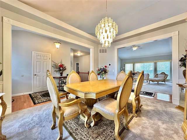 dining space featuring hardwood / wood-style floors and ceiling fan with notable chandelier