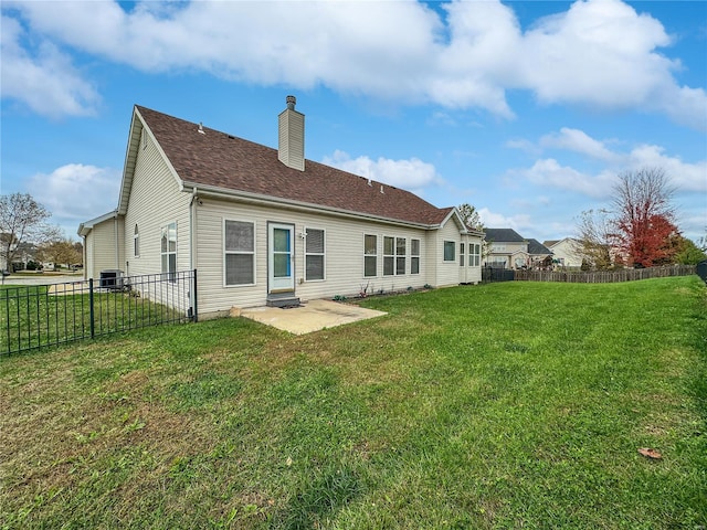 back of property with a patio and a yard