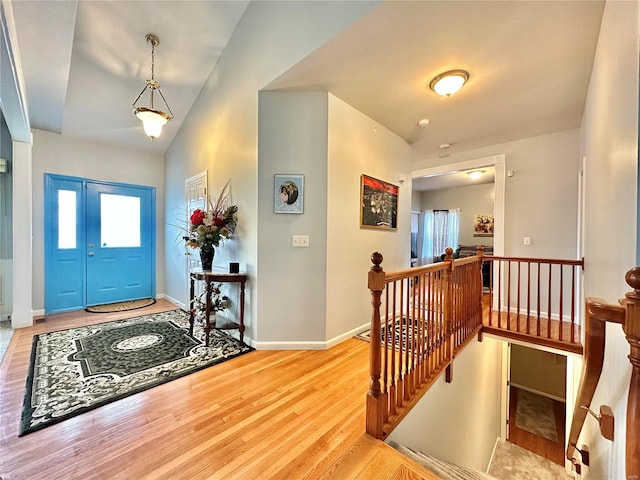 entrance foyer featuring lofted ceiling and hardwood / wood-style flooring