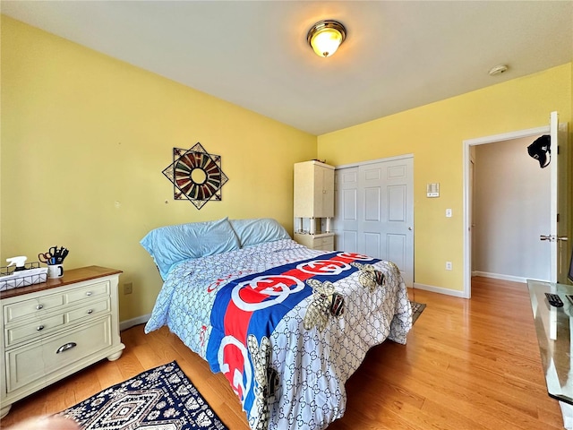 bedroom with a closet and light wood-type flooring